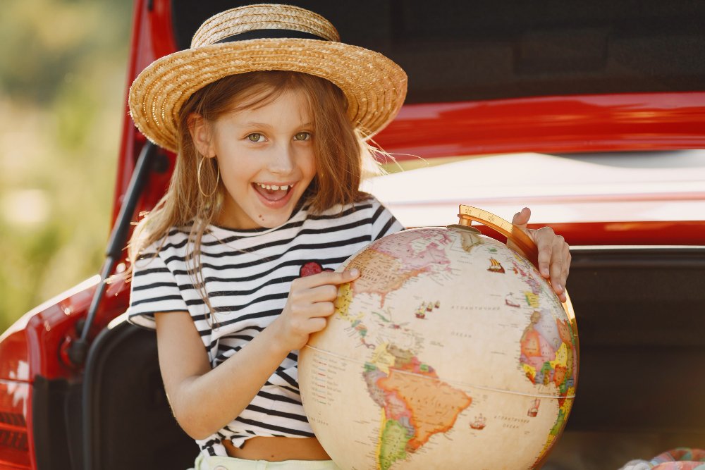 little girl ready go vacations kid red car girl with globe hat